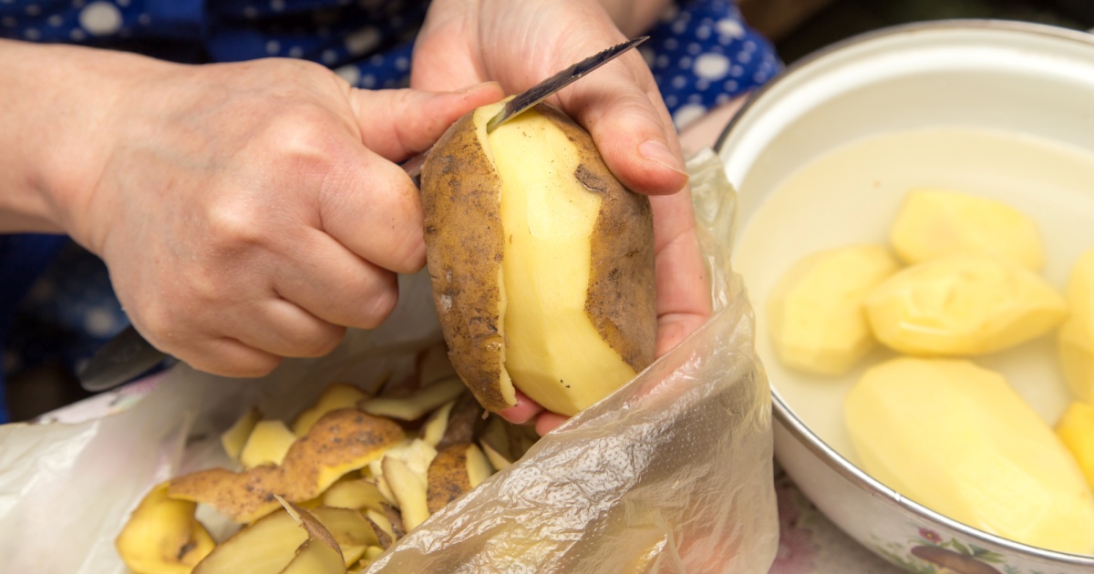 chef peeling potatoes