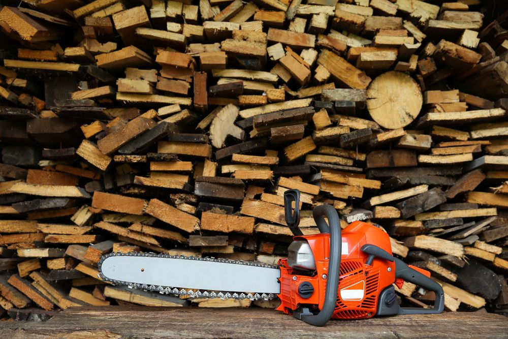 Chainsaw,Is,Against,The,Background,Of,Firewood